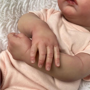Bebê Reborn Liz de 49cm com roupa rosa clara e laço – boneca realista para presente ou coleção Varialle