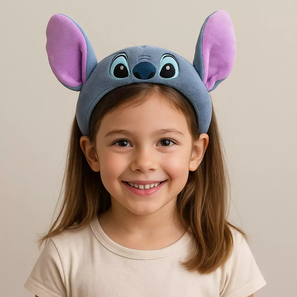 Tiara infantil azul com orelhinhas roxas feitas de pelúcia, posicionada sobre superfície branca, ideal para fantasias e brincadeiras